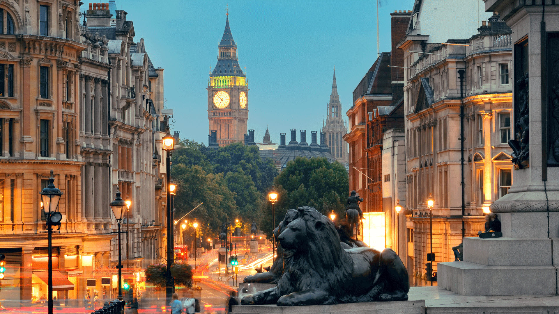 The famous lions guard the base of Nelson's Column. Image courtesy of Shutterstock. Lion statues in Trafalgar Square with view of Big Ben in the background