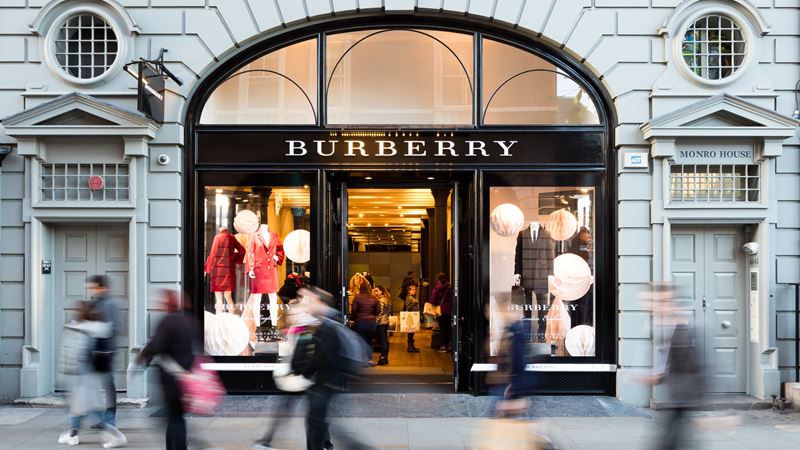 Shoppers walking past Burberry's Covent Garden store