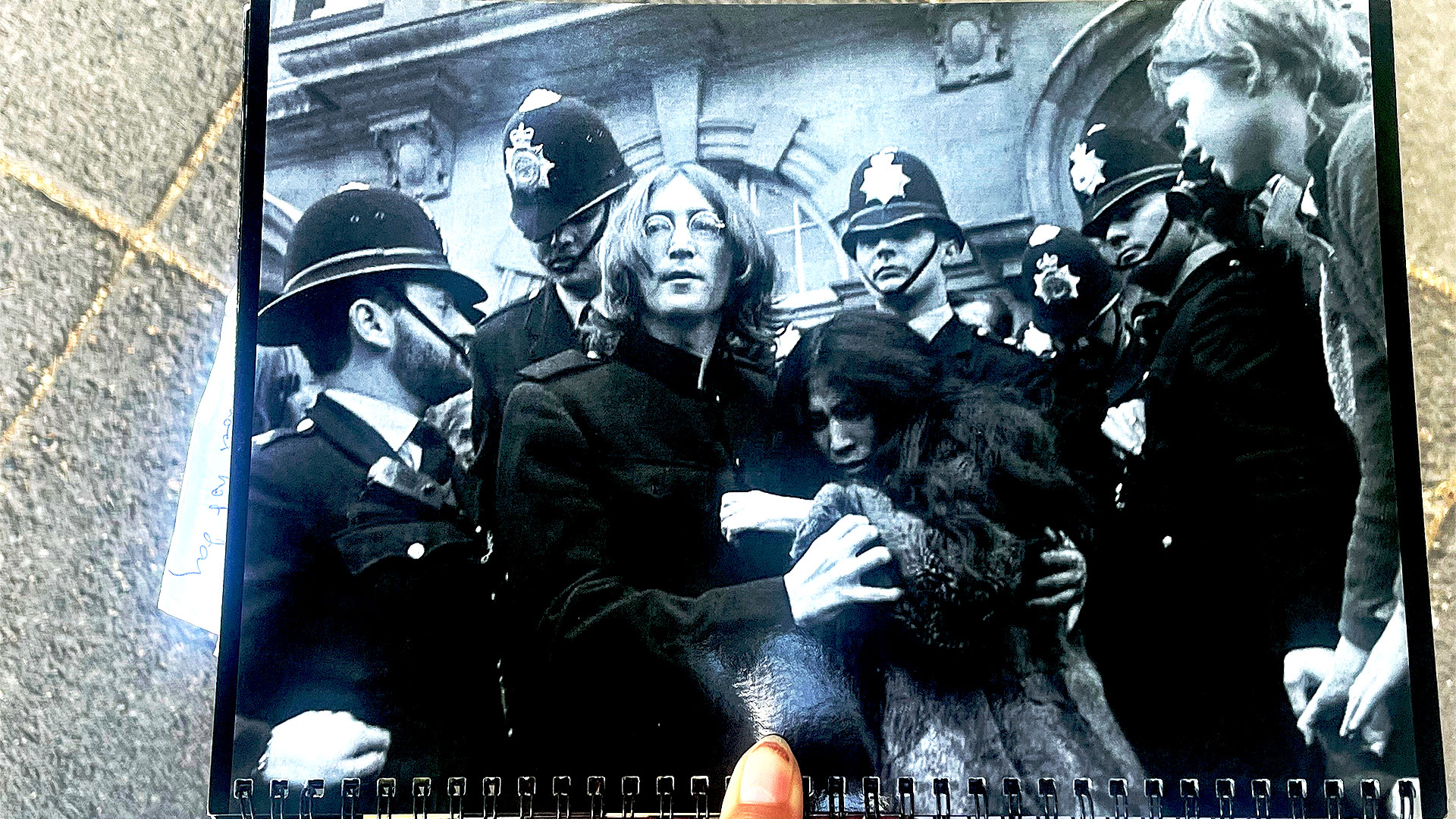 Join a Beatles walking tour of Marylebone and stop by some of the band's former residences. Image courtesy of Carole Rocton. Someone is holding up a black-and-white photograph of John Lennon and Yoko Ono, surrounded by police officers, on the doorstep of their flat on Montagu Square.