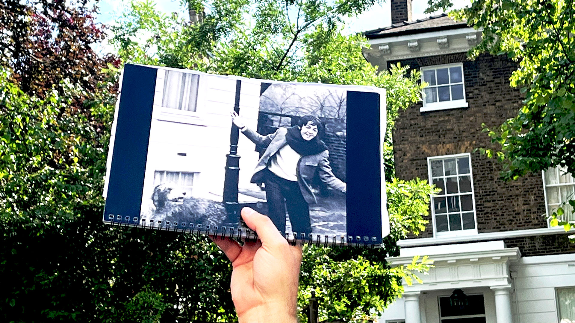 The Beatles walking tour takes you to Abbey Road, which is very close to the current London home of Paul McCartney. Image courtesy of Carole Rocton. Someone is holding up a photograph of Paul McCartney with his dog, Martha, outside his home in St John's Wood.