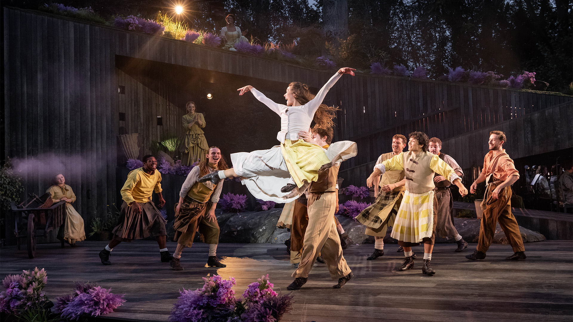 Chrissy Brooke dazzles in the role of Maggie Anderson in the 2025 revival of Brigadoon. Image courtesy of London Theatre Direct/Mark Senior. The cast of Brigadoon dance in the opening scene