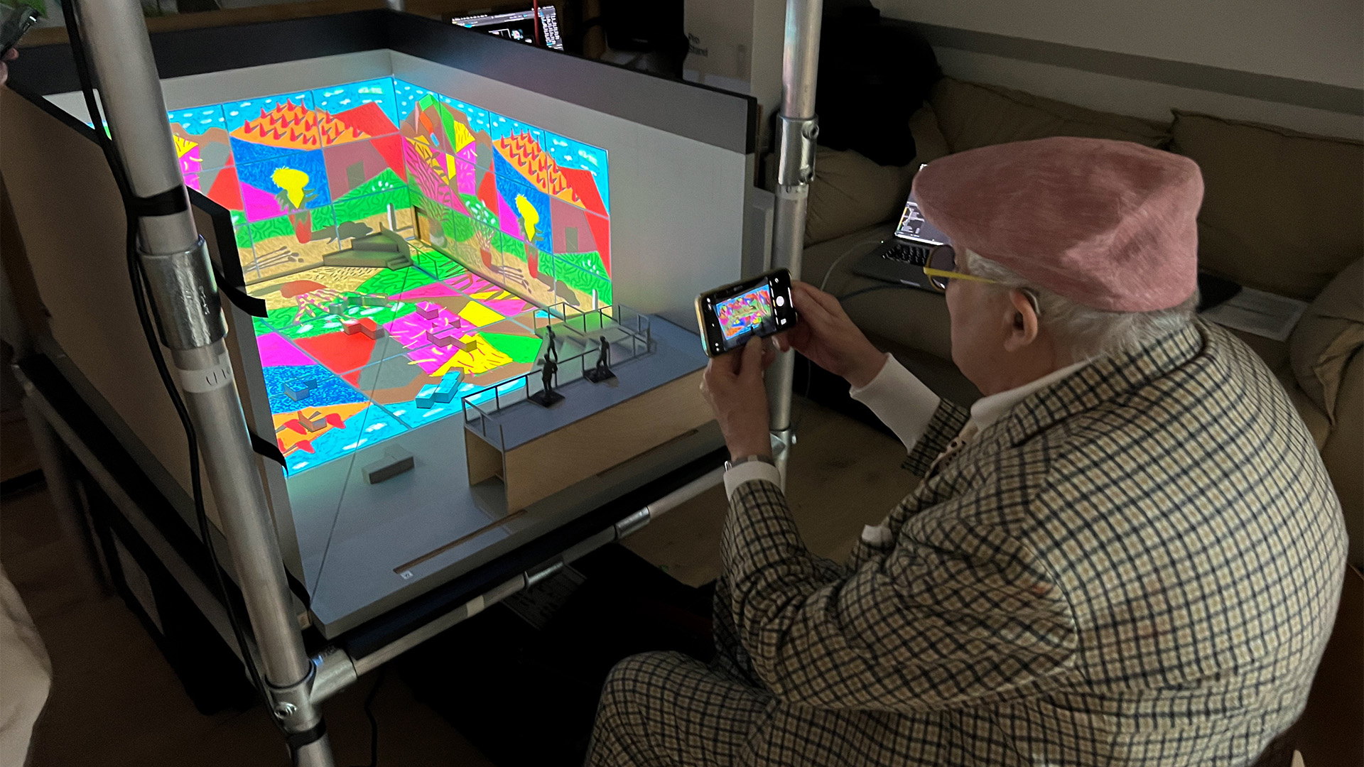Hockney photographs a model of his exhibition at Lightroom. Image courtesy of Lightroom. David Hockney photographs a model of his show at Lightroom. Image courtesy of Lightroom.