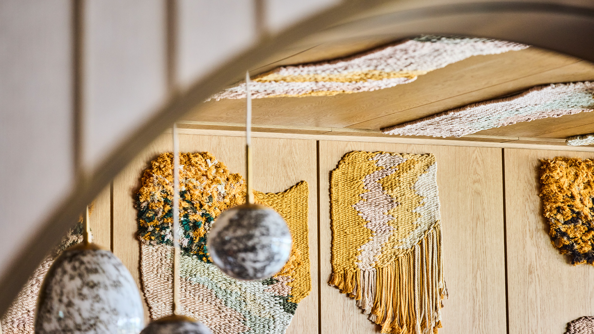Striking textiles are woven into wood walls at Brasserie Constance. Image courtesy of Fulham Pier. Textile artworks woven into the wooden walls of Brasserie Constance at Fulham Pier