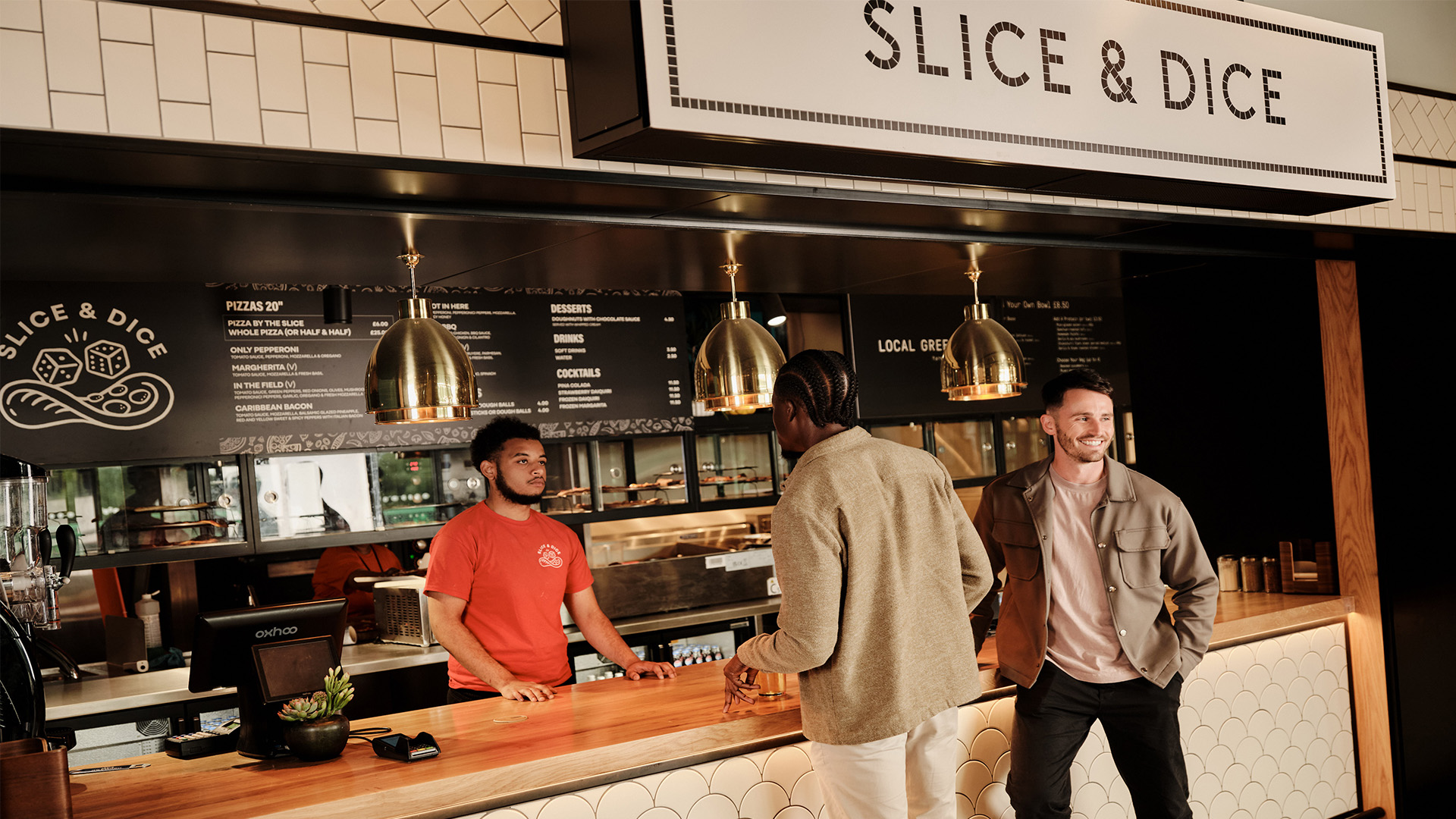 Slice & Dice at Fulham Pier. Image courtesy of Fulham Pier. Two men collecting pizza from Slice & Dice at Fulham Pier