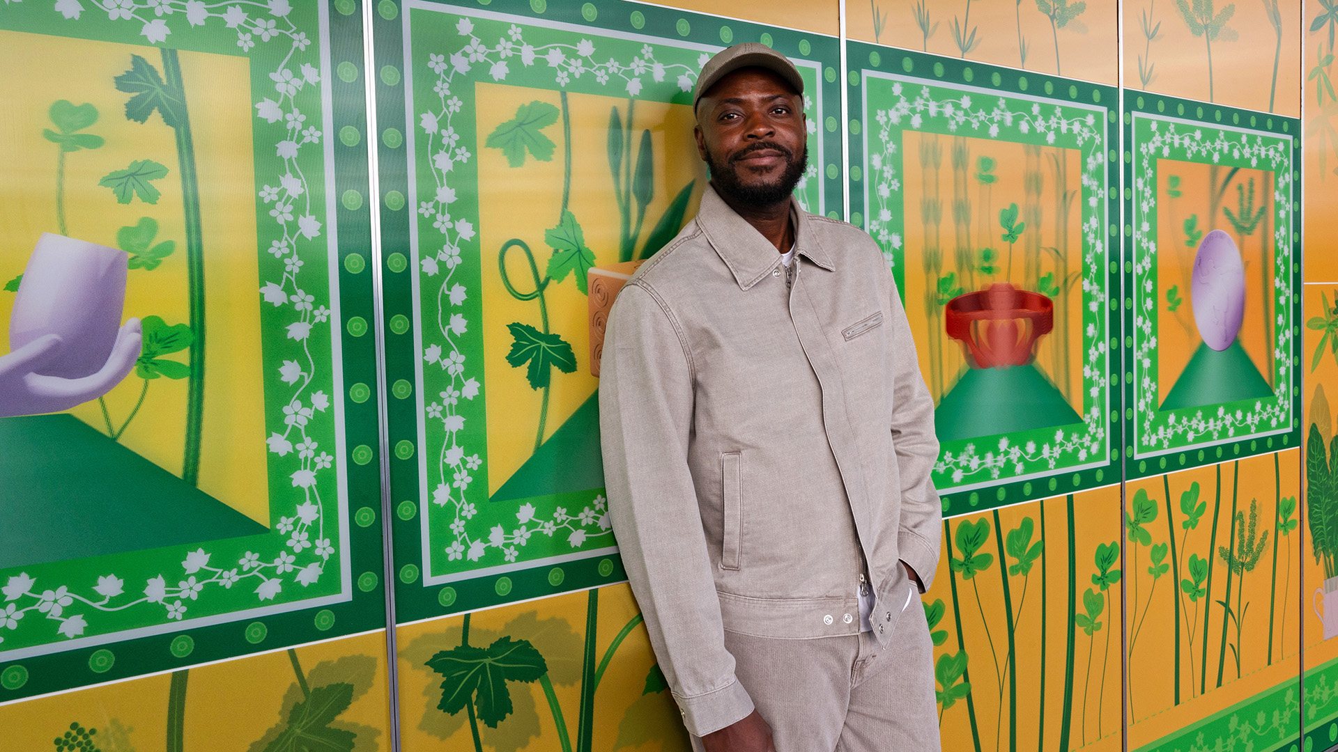 British-Nigerian artist Yinka Ilori's artwork 100 Found Objects at Fulham Pier. Image courtesy of Fulham Pier. Yinka Ilori stands alongside his striking artwork on the exterior of Fulham Pier