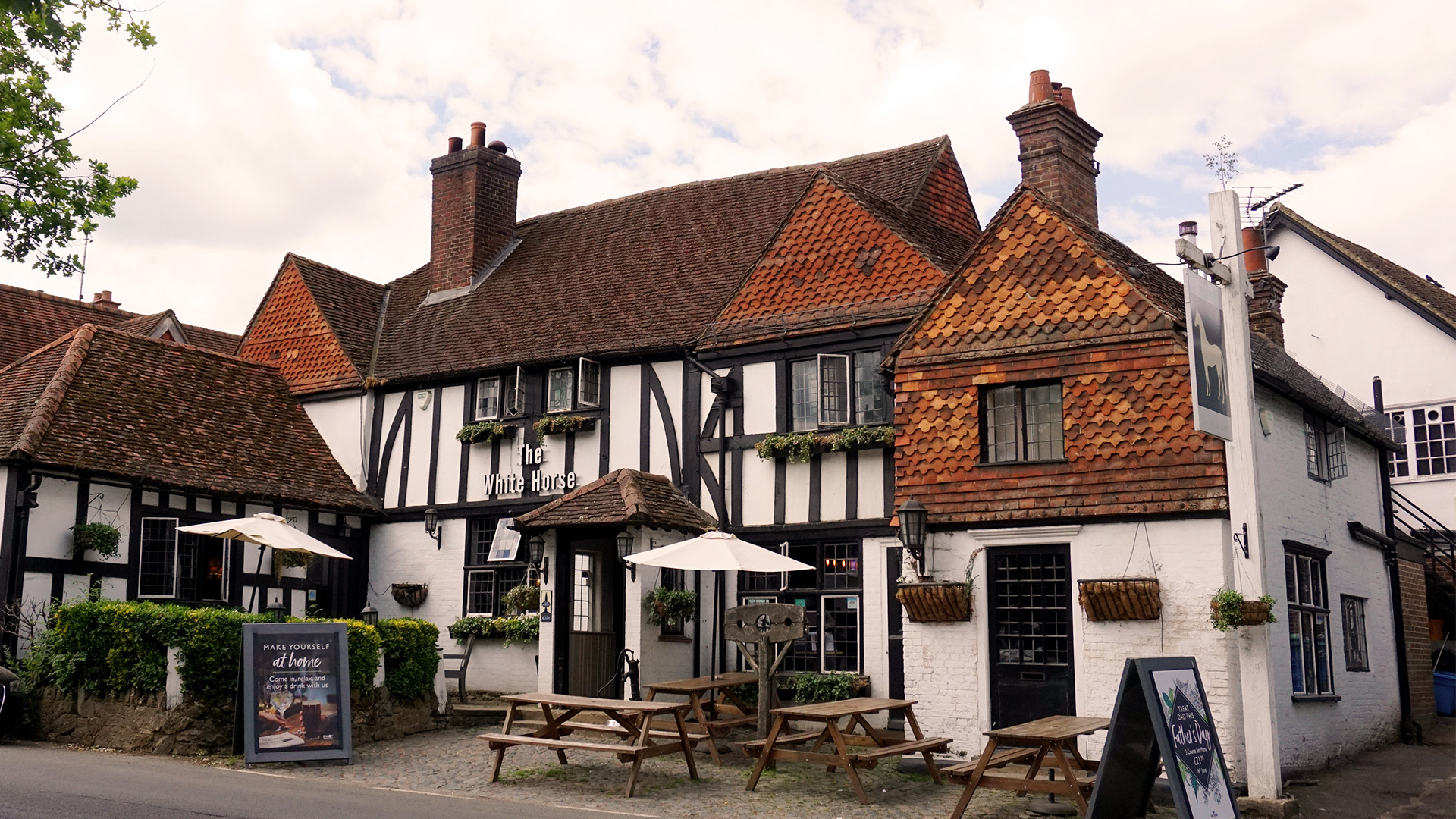 The White Horse in Shere, Surrey. Image courtesy of Shutterstock. Exterior of The White Horse pub in Shere, Surrey.