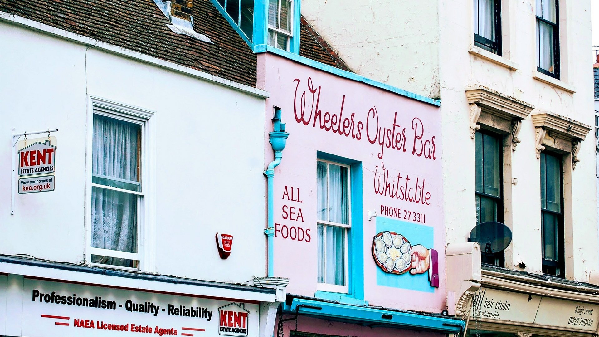 Wheeler's Oyster Bar in Whitstable, Kent. Image courtesy of Amy Asher/Unsplash. Pink exterior of Wheeler's Oyster Bar