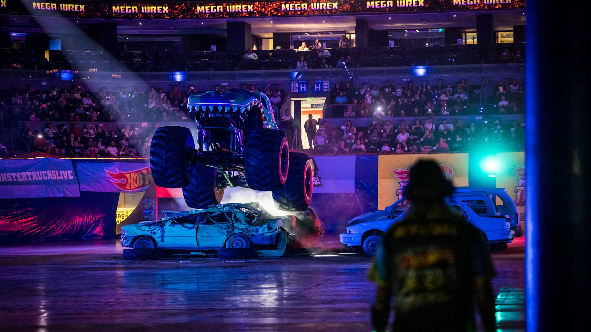 Enjoy a roaring spectacle as Monster Trucks brings its live show from the US to the UK. Image courtesy of Mance Communications. A Monster Truck jumps over a partly crushed car within an indoor arena.