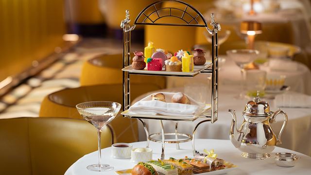 At Sketch, a Regency-style stand of mini cakes and scones sits next to a table of finger sandwiches part of an afternoon tea celebrating Jane Austen.