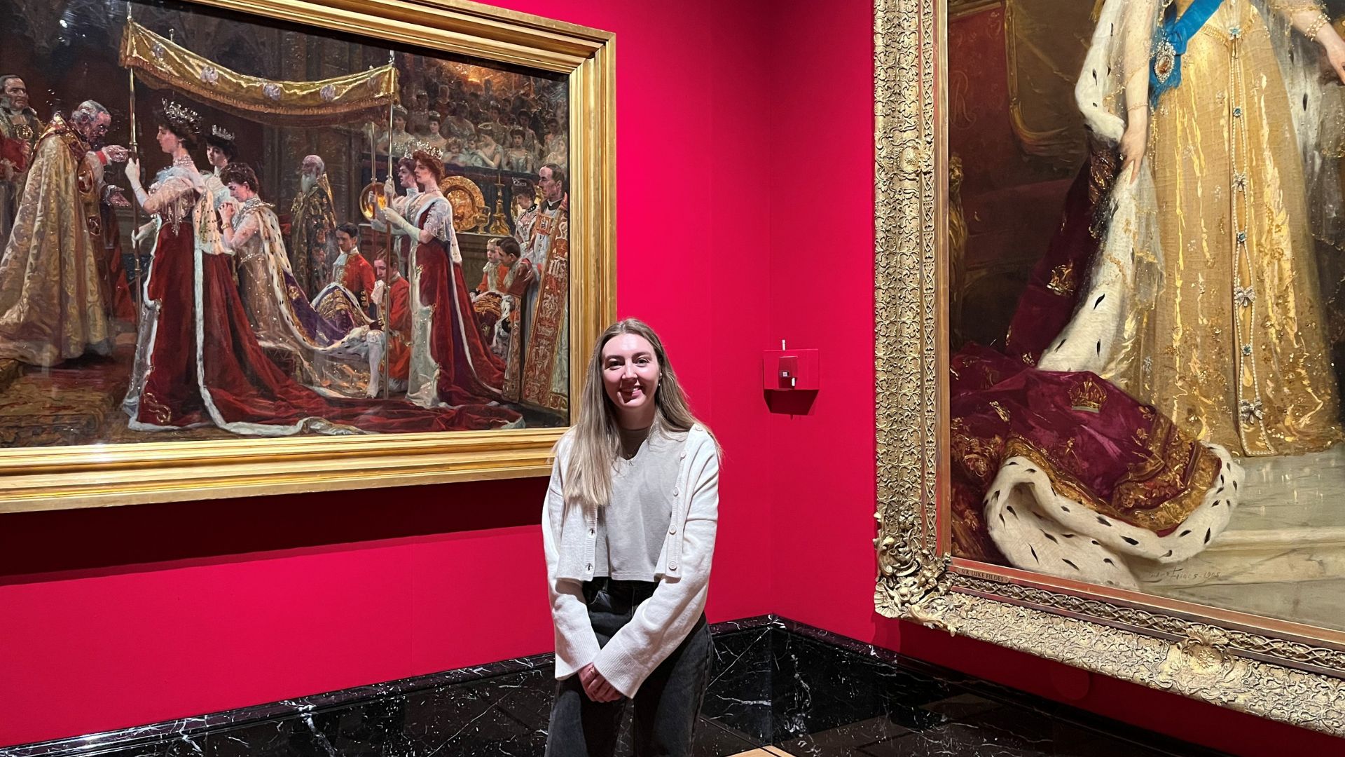 Explore the elegance of the Edwardian era at The King’s Gallery. © Visit London/Charlotte Pritchard. Person standing in front of painting showcasing royal coronation at The King's Gallery.