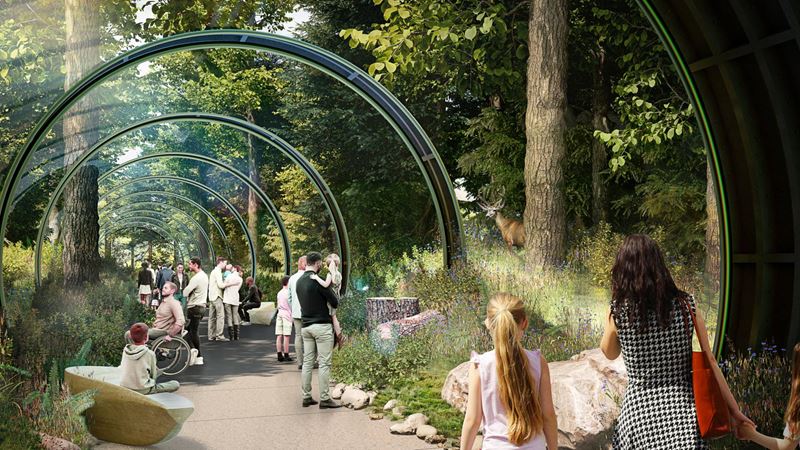 People walk through a tunnel with displays showing trees and grasses, at The London Tunnels.