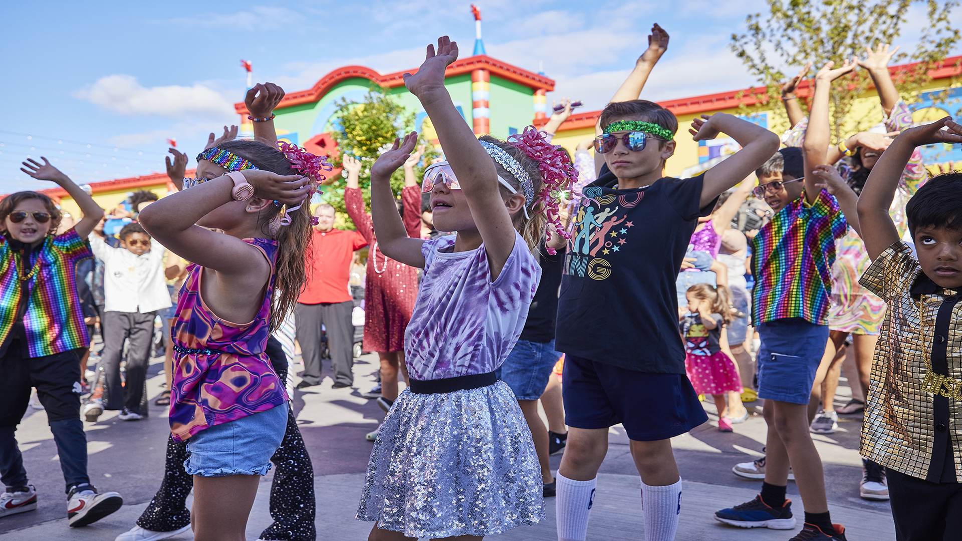 Kids celebrate the upcoming Lego Festival. Image courtesy of Merlin Entertainment A crowd of kids in fancy dress up celebrate the upcoming LEGO Festival at Legoland on a bright day.