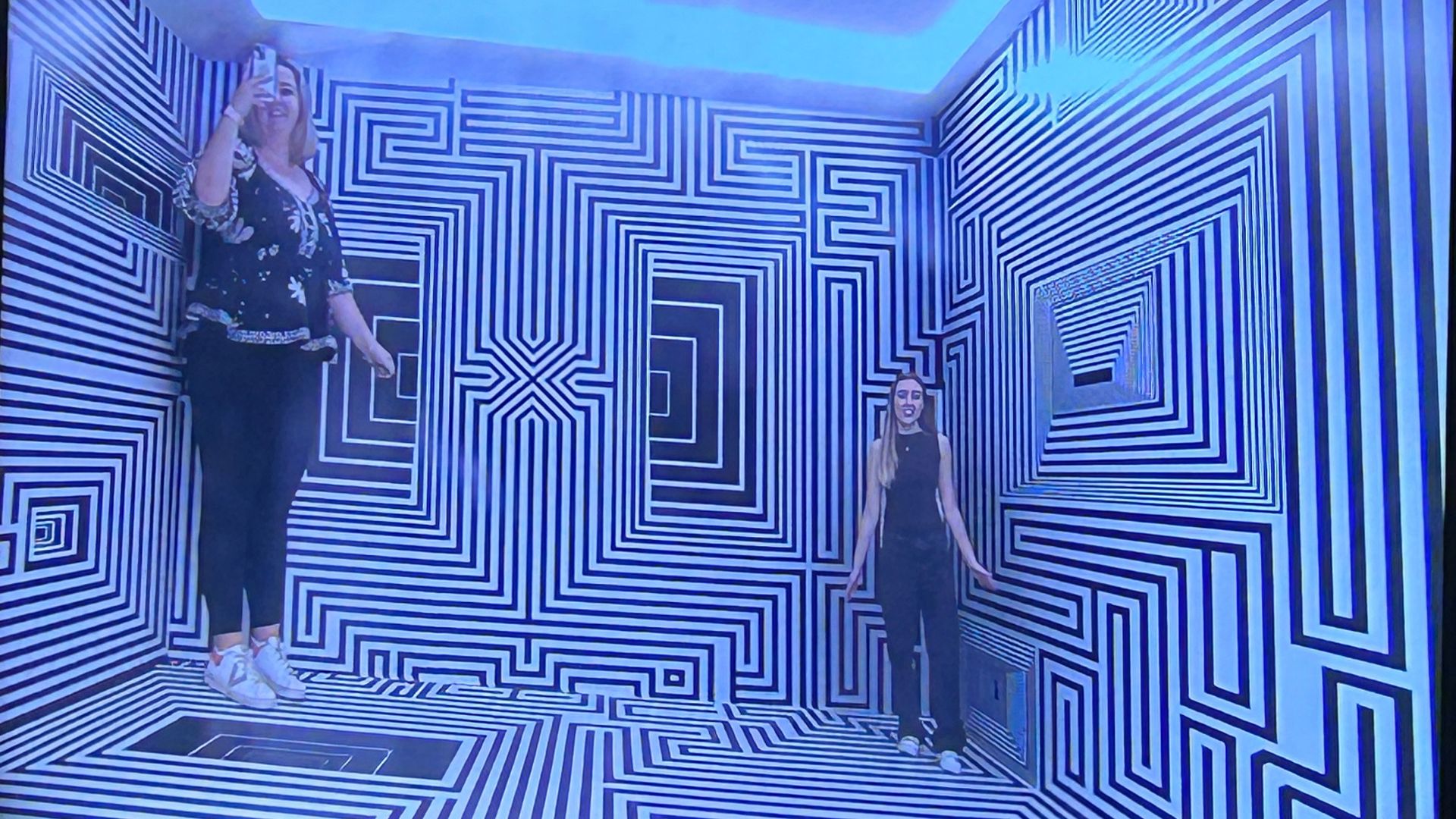 Snap lots of photos in different immersive exhibition spaces at Twist Museum. © Visit London/Hannah Cornish two women stood in a black and white room, with one appearing much taller than the other