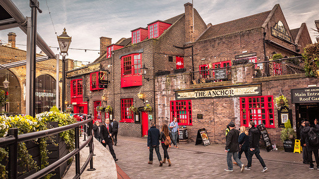 The Anchor. Image courtesy of Shutterstock. People stroll past the riverside The Anchor pub