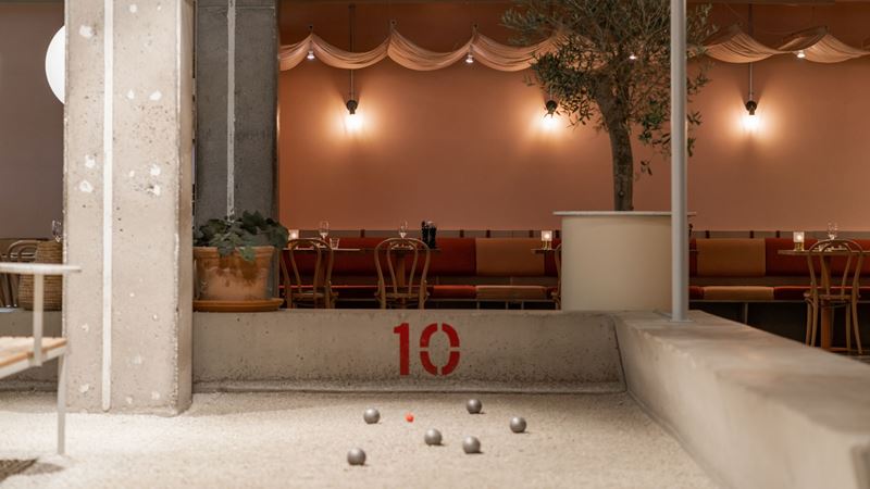 A set of metal petanque balls on the gravel at boulebar in spitalfields.