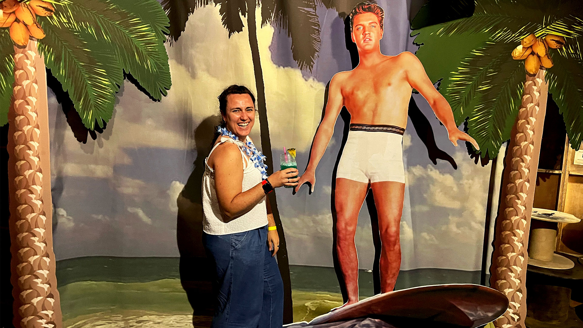 Halfway through the Elvis Evolution experience, step into the Blue Hawaii Bar and take a selfie with the surfing Elvis. Image courtesy of Carole Rocton. A woman stands next to a cardboard cut-out of Elvis surfing in Hawaii as part of the Elvis Evolution Experience.