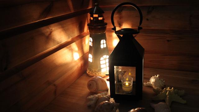 Can you break out of the Archimedes Inspiration - AI Escape? Image courtesy of Archimedes Inspiration - AI Escape. A black lantern sits next to a lighthouse figure with lights.