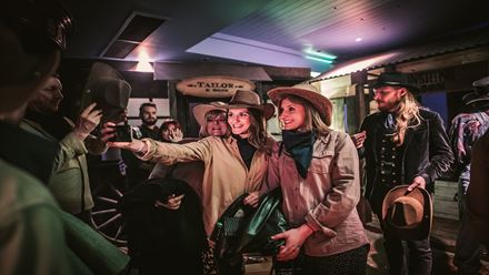 Visit the local tailor and be fitted in classic Western attire at the Moonshine Saloon immersive experience. Image courtesy of Golden Tours.