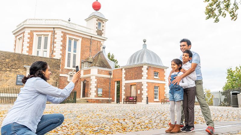 Enjoy a day out with the whole family for the May half-term school break. Credit: Visit Greenwich. Image courtesy of Visit Greenwich. A mum kneeling to take a photo of her kids and partner in front of the Royal Observatory, Greenwich.