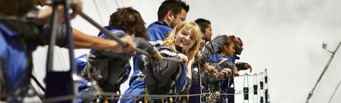 A photo of a young girl looking at the camera, smiling, while enjoying the Up at The O2 walkway.