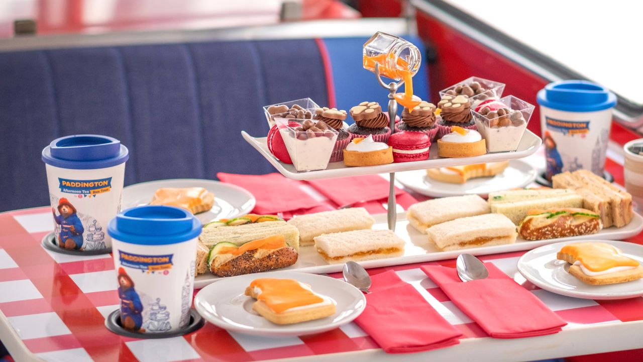 Paddington Bear afternoon tea on a Brigit's Bakery Afternoon Tea Bus Tour. Image courtesy of Golden Tours. A table on an afternoon tea bus tour covered in paddington bear themed sweet and savoury treats and drinks.