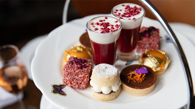 Mini patisseries laid out on a plate for afternoon tea.