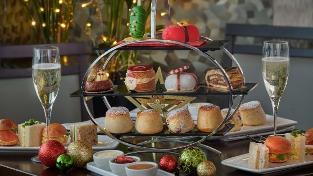 A table at park lane hilton hotel covered in christmas treats and champagne.