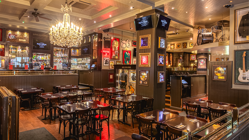 Devour delicious burgers, chicken wings and more at the iconic Hard Rock Cafe. Credit: Hard Rock Cafe. Image courtesy of Hard Rock Cafe. The Hard Rock Cafe restaurant interiors with pictures and memorabilia on the walls