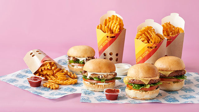 Enjoy healthy fast food © LEON. Image courtesy of LEON. A selection of burgers and fries in front of a pink background