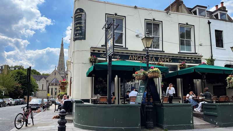Head to The Anglesea Arms, a cosy pub tucked away just outside Ravenscourt Park. Credit: Metropolitan Pub Company. Image courtesy of Metropolitan Pub Company. Anglesea Pub exterior on a clear sunny day with church in the background.