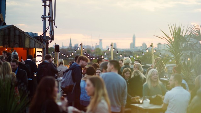 Make memories with a backdrop of the skyline at one of London's accessible rooftop bars. Image courtesy of the Bussey Rooftop Bar. A busy rooftop bar with fairy lights and stunning views across London's skyline.