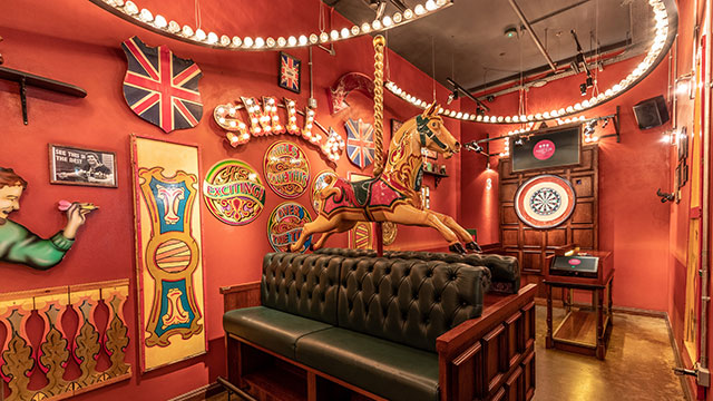 Flight Club Shoreditch © Red Engine. Image courtesy of Red Engine A Victorian-inspired fairground horse in front of a dart board inside Flight Club