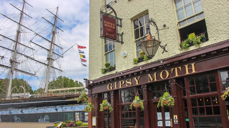 Soak up the sun next to Greenwich’s iconic Cutty Sark at The Gipsy Moth. Credit: Shutterstock. Image courtesy of Shutterstock. The Gipsy Moth pub facade within view of the famous Cutty Sark in Greenwich.