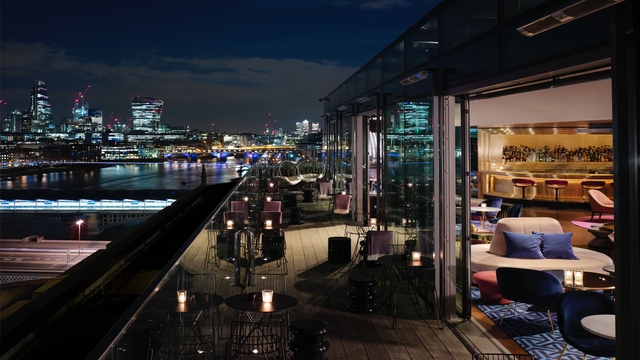 Sip on drinks at Sea Containers with the view of London's cityscape. Credit: Sea Containers. Image courtesy of Sea Containers. An outside rooftop bar terrace, overlooking the London skyline at night