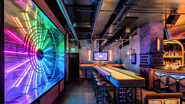 An interactive shuffleboard at Electric Shuffle © Red Engine. Image courtesy of Red Engine An interactive shuffleboard next to a multi-coloured light