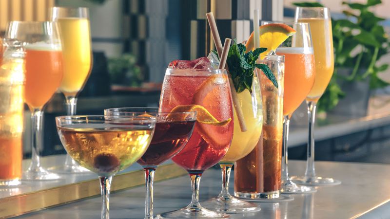 Flick through a menu of classics or contemporary cocktails with a twist at Swift in south London. Credit: Swift Borough. Image courtesy of Swift Borough. A photo of a lineup of different colourful cocktails in glasses of different shapes and sizes at Swift Borough