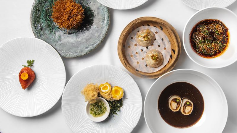 Experience Michelin-starred Chinese dining at A.Wong in Victoria. Credit: James Gillies. Image courtesy of A.Wong A bird's-eye photo of plates of Chinese dim sum from A.Wong on a table including dumplings and dishes with meat with sauce
