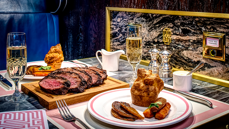 Press for champagne while enjoying a delicious Sunday roast at Bob Bob Ricard. Credit: Paul Winch-Furness. Image courtesy of Bob Bob Ricard. Sunday roast dishes accompanied by glasses of champagne at Bob Bob Ricard