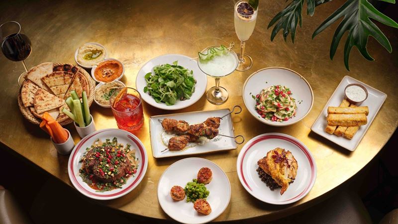 Flick through a menu of Middle Eastern delights at gluten-free friendly CERU. Credit: Jodi Hinds. Image courtesy of CERU. A birds eye shot of different Middle Eastern dishes from CERU on a table with a glass of bubbles