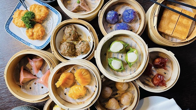 Try an assortment of dishes at Plum Valley. Image courtesy of Plum Valley. An assortment of colourful dim sum in small wicker baskets