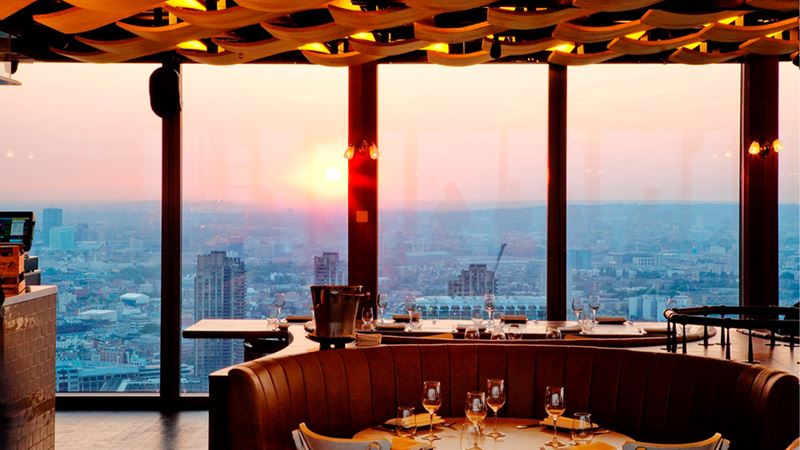 Visit Duck & Waffle, London's highest 24/7 restaurant. Credit: Steven Joyce. Image courtesy of Duck & Waffle. Sunset view of London from Duck & Waffle in Liverpool Street.