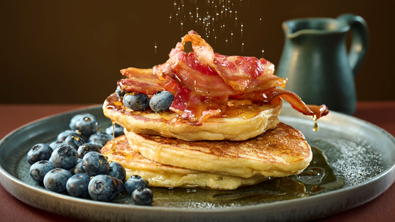 Kids can build their very own pancake stack with a choice of delicious toppings at Where The Pancakes Are. Credit: Howard Shooter. Image courtesy of Where The Pancakes Are. A stack of three pancakes on a round plate