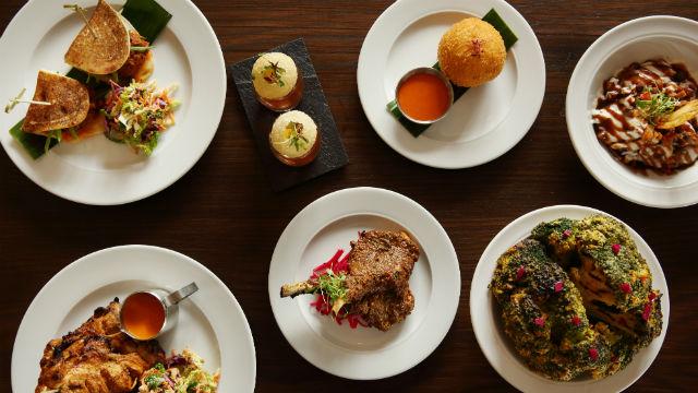 Traditional family recipes with a modern twist at Gunpowder. Image courtesy of Gunpowder. high angle image of a selection of small plates with Indian food on