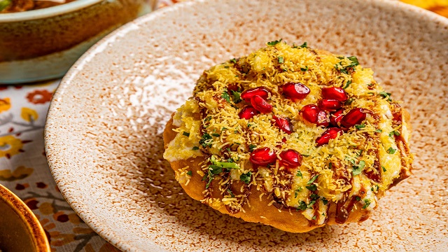 Michelin star Upscale Indian dishes from the southwest coast. Image courtesy of Trishna. a cream bowl speckled with an orange pattern, with an Indian dish presented in the middle