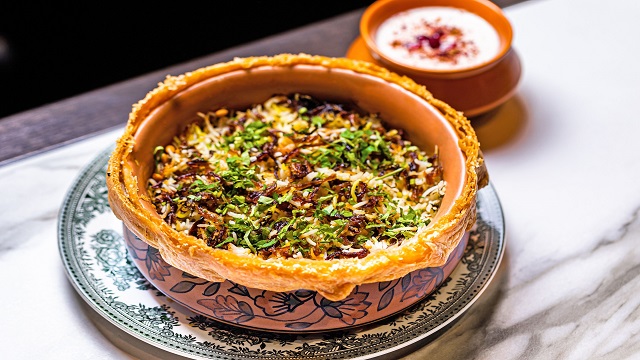 Wild muntjac biryani served at Gymkhana. Image courtesy of Gymkhana. traditional indian pottery dish with a wild muntjac biryani served inside