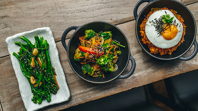 Three different plates of food on a table, taken from above.