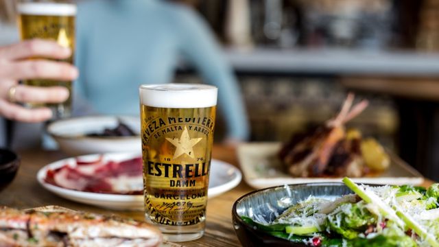 Jose, London Bridge. Image courtesy of Jose Pirazzo. Photo Credit: Adele Audisio A table with various plates of food and two beers, one being held by a diner in a blue jumper.