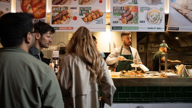 A person serves food at juma street food stall in borough.
