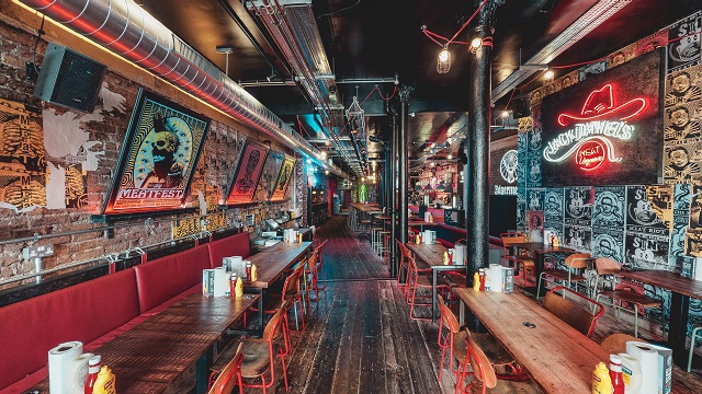 Burgers and cocktails at the trendy MEATliquor. Image courtesy of MEATliquor W1. trendy urban bar with stool seating, graffiti art walls and neon signs