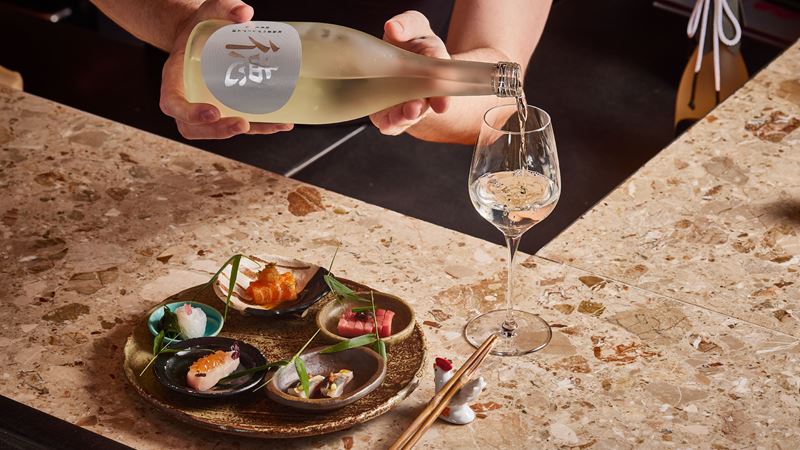 Experience Japanese fine dining at Humble Chicken and enjoy a selection of Yakatori chicken dishes. Credit: Humble Chicken. Image courtesy of Humble Chicken. A plate featuring a selection of Japanese tapas is disposed on a counter at Humble Chicken, a Michelin star restaurant in London.